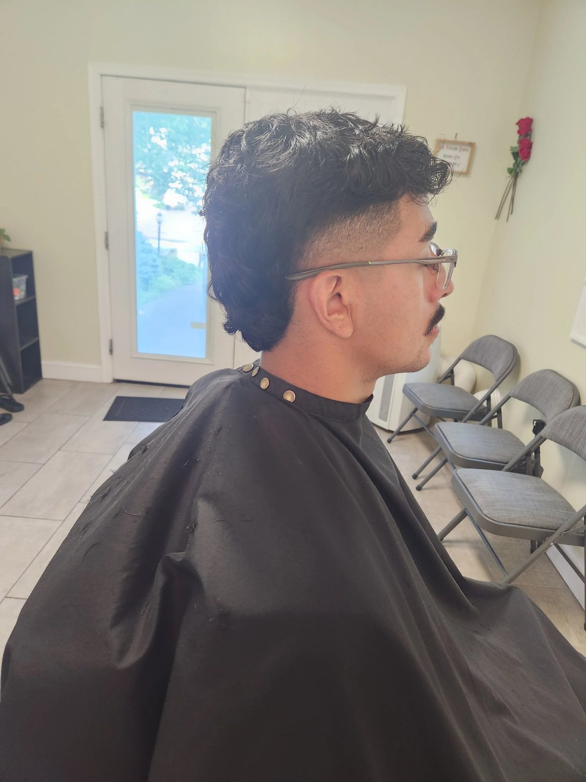 Curled dark layered style at Happy Barber