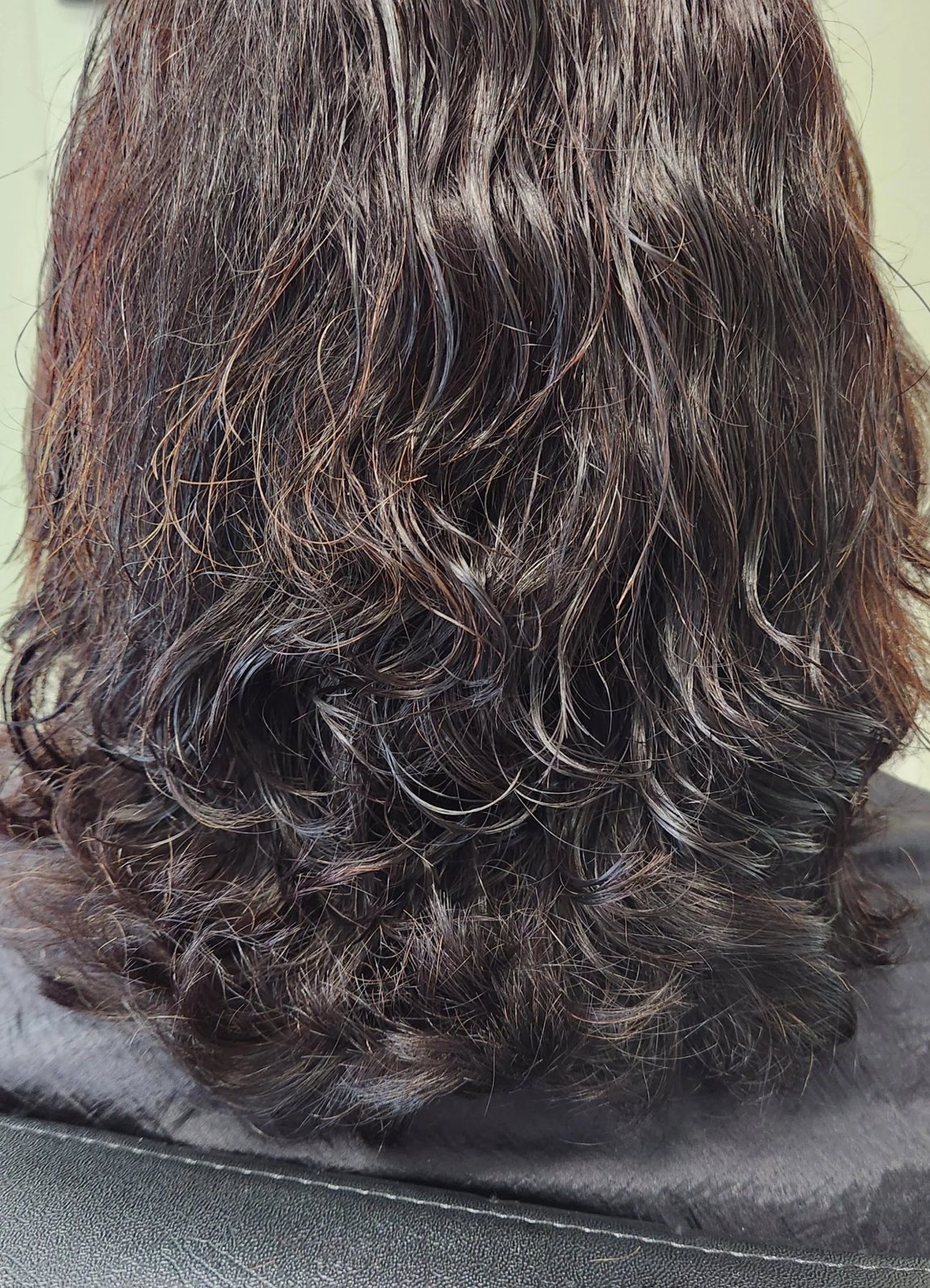 Long dark layered haircut at Happy Barber