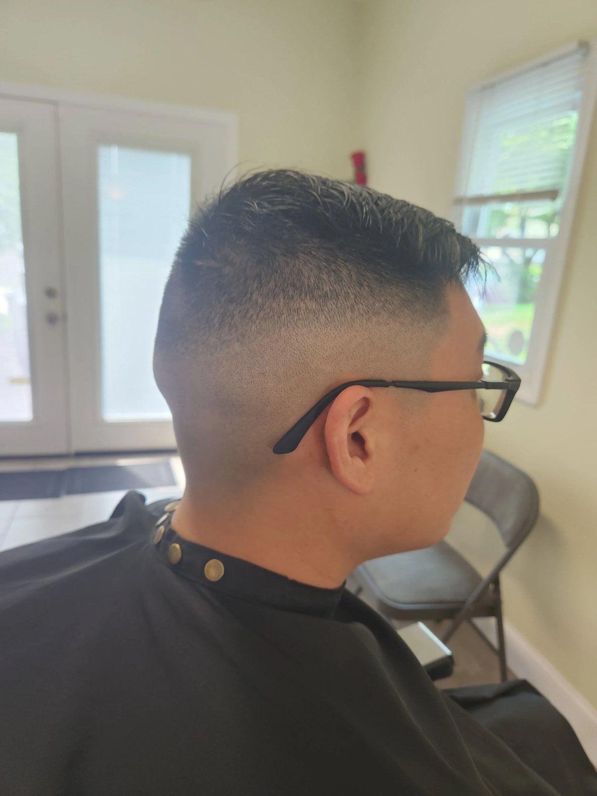 Slicked side part fade at Happy Barber