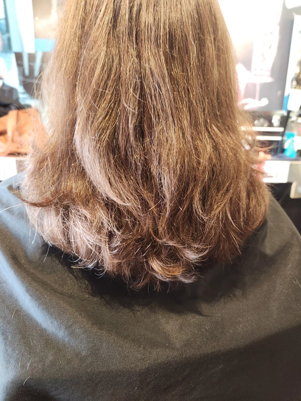 Women's sleek blunt haircut at Happy Barber
